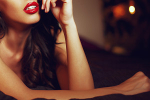 Sexy woman with red lips on bed closeup, sensual lover